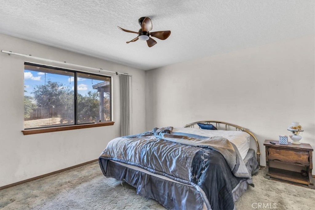 7633 I Avenue Hesperia, CA 92345 - Photo 14 of 22 a bedroom with a bed and a painting on the wall