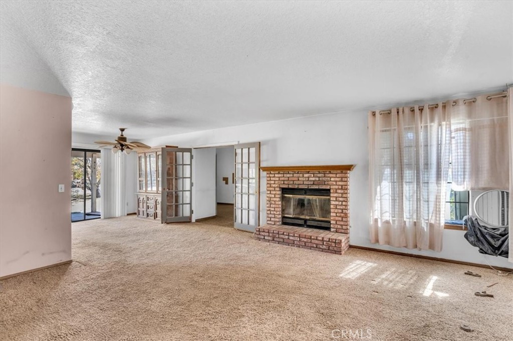7633 I Avenue Hesperia, CA 92345 - Photo 3 of 22 an empty room with fireplace and windows