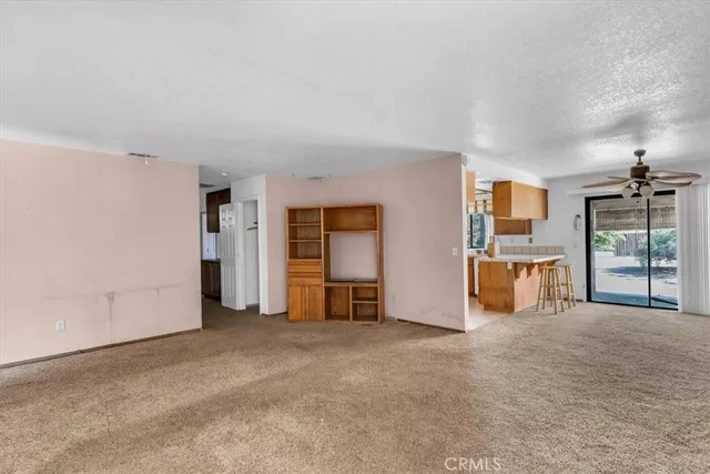 an empty room with furniture and a window
