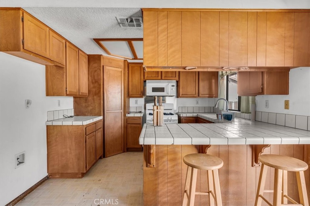 7633 I Avenue Hesperia, CA 92345 - Photo 6 of 22 a kitchen with stainless steel appliances granite countertop a sink refrigerator and cabinets