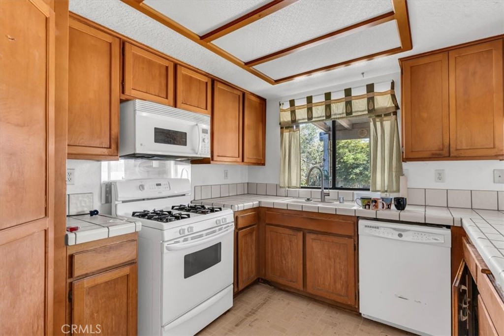 7633 I Avenue Hesperia, CA 92345 - Photo 7 of 22 a kitchen with a sink stove top oven and cabinets