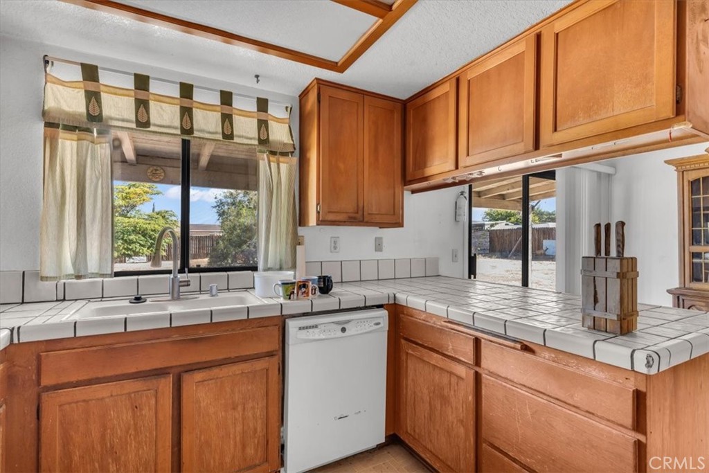 7633 I Avenue Hesperia, CA 92345 - Photo 8 of 22 a kitchen with stainless steel appliances granite countertop a sink and cabinets