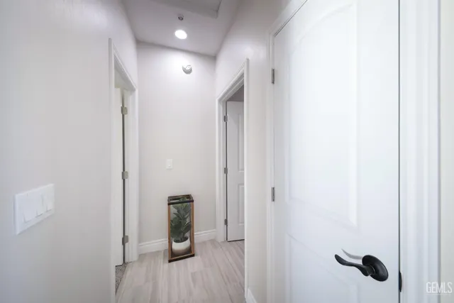 a view of a hallway with wooden floor