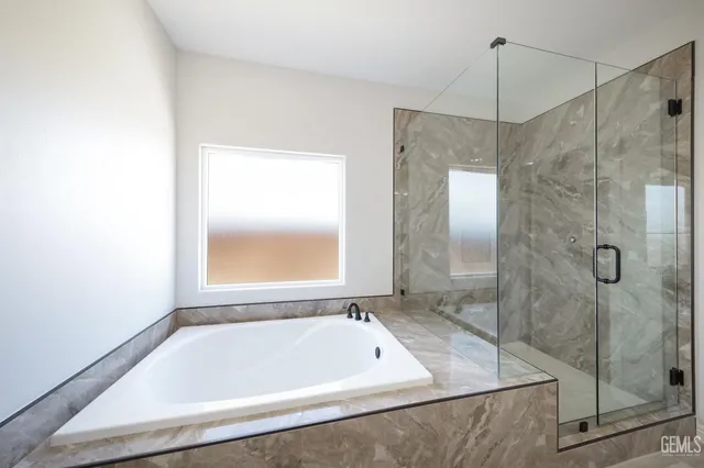 a bathroom with a bath tub and shower