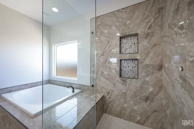 a bathroom with a tub and shower