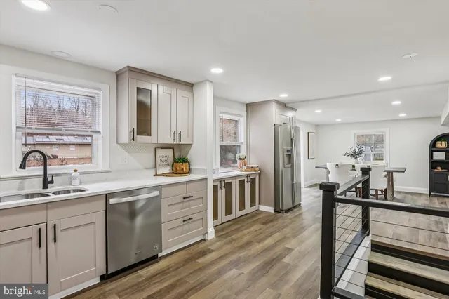 a kitchen with stainless steel appliances granite countertop a sink stove and cabinets