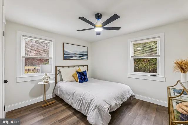 a bedroom with a bed and a ceiling fan