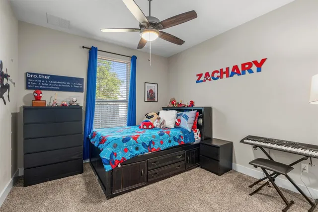 a bed room with a bed a dresser and a window