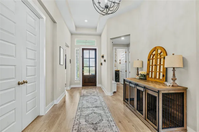 a view of a hallway with entryway wooden floor and front door