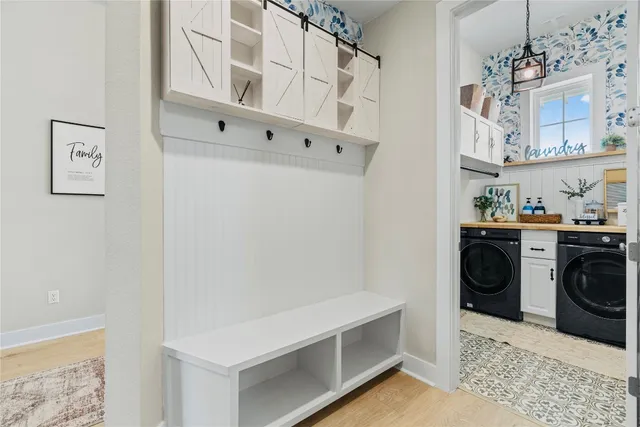 a view of cabinets and washer in a white room