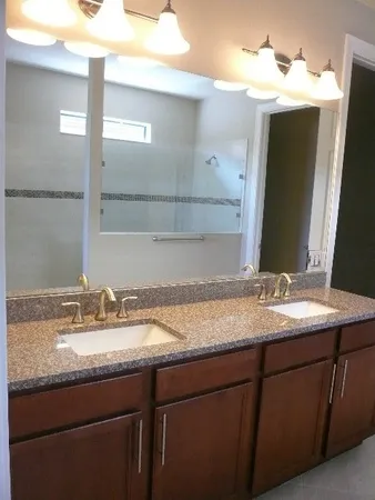 a white toilet sitting next to a bathroom sink