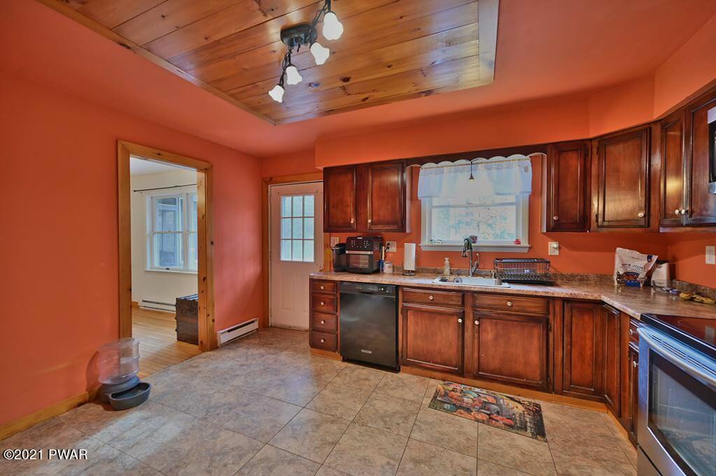 127 Estates Road Greentown, PA 18426 - Photo 29 of 85 a kitchen with stainless steel appliances granite countertop wooden cabinets a sink and dishwasher