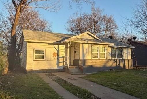 3313 Hatcher Street Fort Worth, TX 76119 - Photo 1 of 15 a front view of a house with a yard porch and outdoor seating