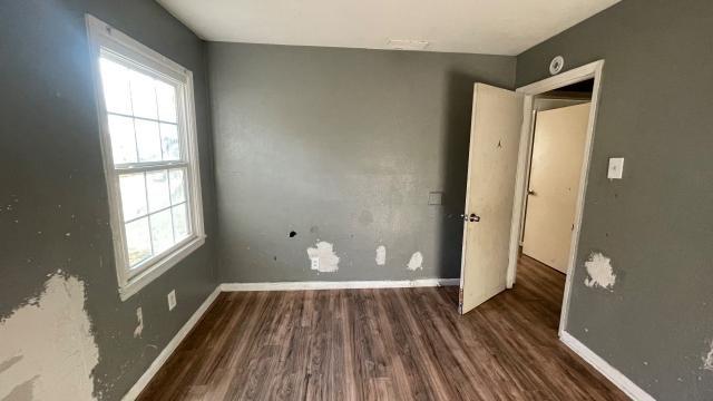 3313 Hatcher Street Fort Worth, TX 76119 - Photo 12 of 15 a view of an empty room with wooden floor and a window