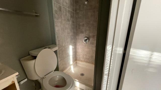 3313 Hatcher Street Fort Worth, TX 76119 - Photo 15 of 15 a bathroom with a toilet and a mirror