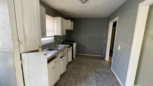 3313 Hatcher Street Fort Worth, TX 76119 - Photo 7 of 15 a kitchen with a stove and a refrigerator