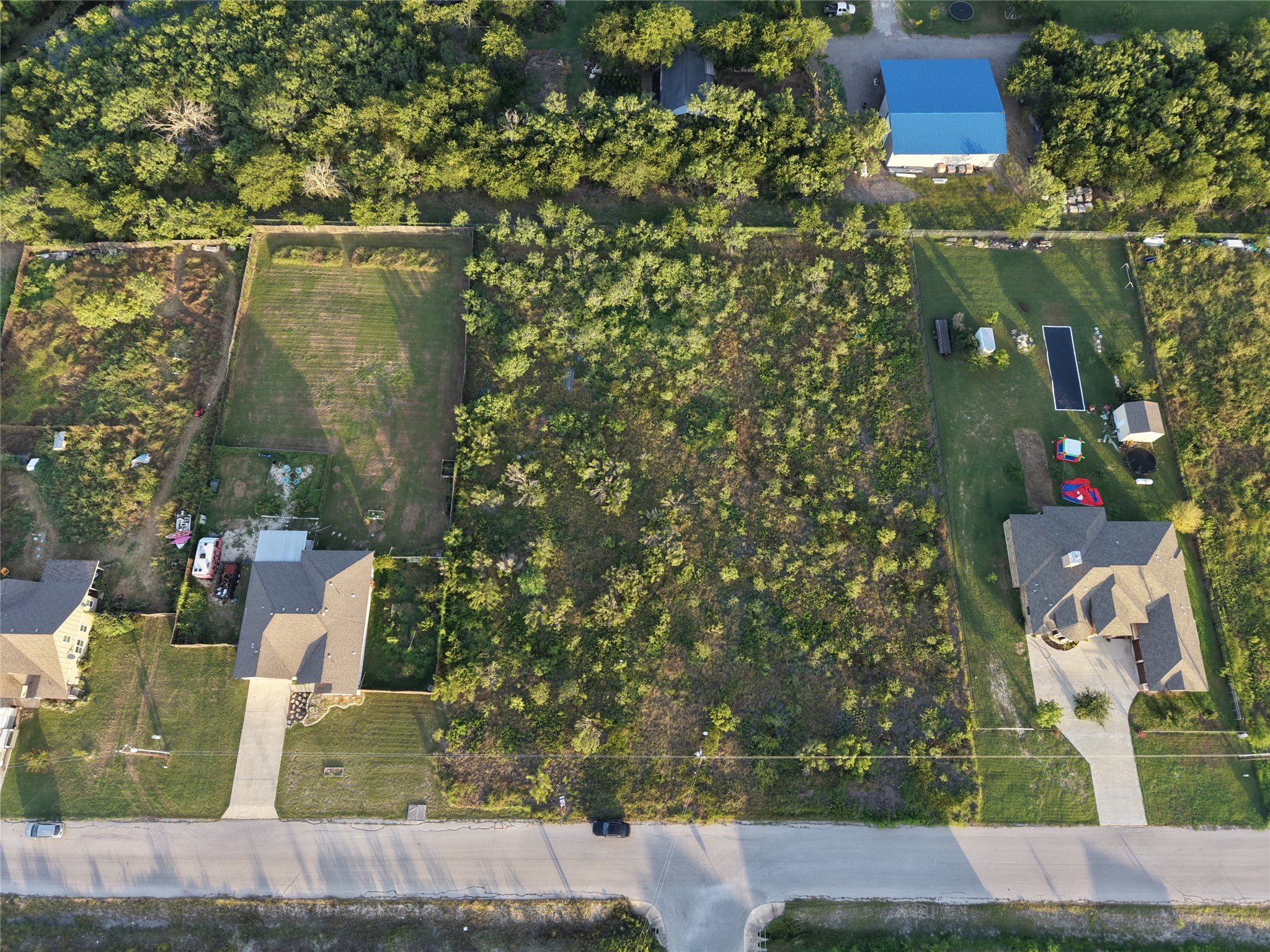 232 East Ridge Lane Kyle, TX 78640 - Photo 23 of 36 A prime building lot awaits your vision, surrounded by established residences and lush greenery.