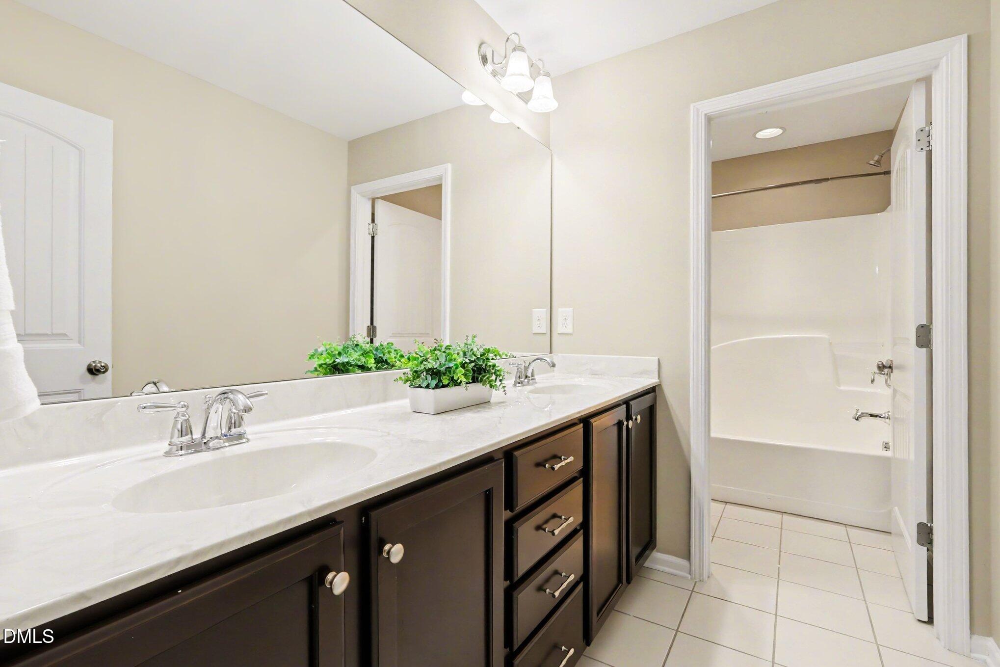 2409 Memory Ridge Drive Raleigh, NC 27606 - Photo 18 of 36 a bathroom with a sink and a mirror