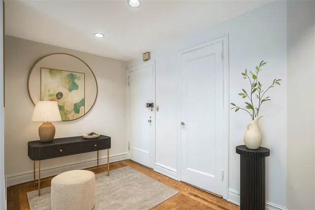 a room with painting on the wall and a mirror