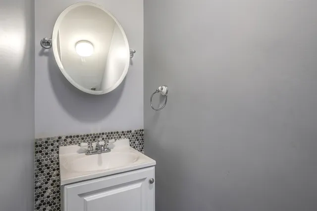 a bathroom with a sink a mirror and a shower