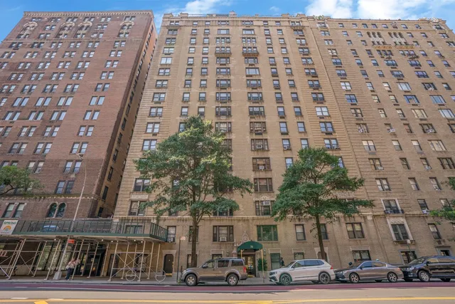 a view of a patio with table and chairs potted plants and floor to ceiling window