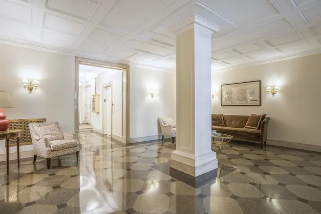 a view of a livingroom with furniture and floor to ceiling window