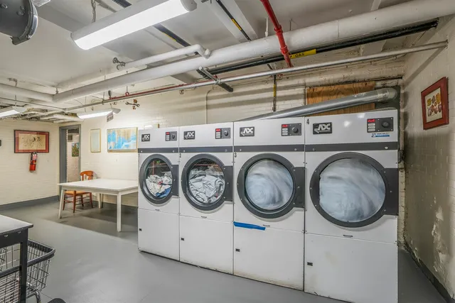 a living room with furniture and painting on the wall