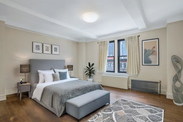 a bedroom with a bed couch and window