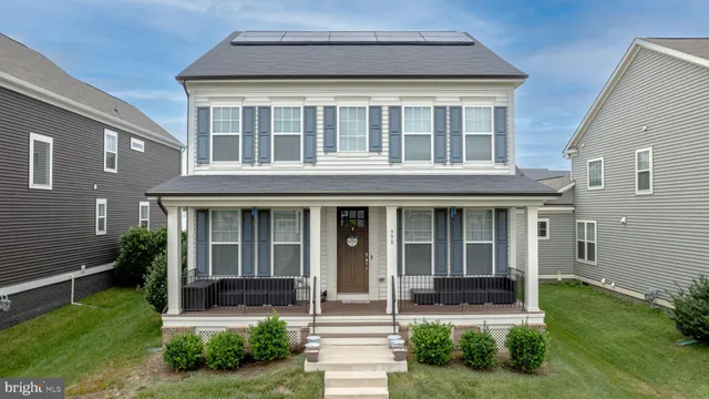 a front view of a house with garden and porch