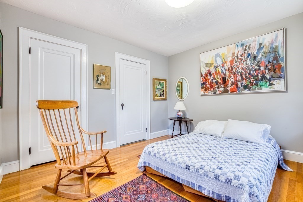 222 Bonad Road Brookline, MA 02467 - Photo 19 of 30 a bedroom with a bed and wooden floor