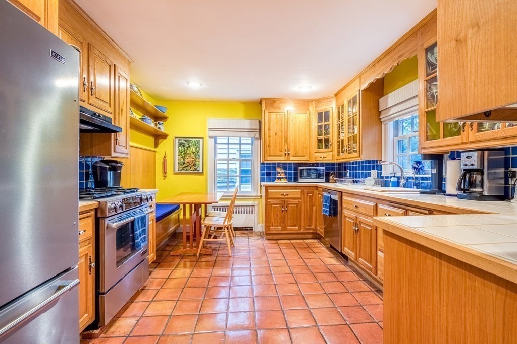 222 Bonad Road Brookline, MA 02467 - Photo 10 of 30 a kitchen with stainless steel appliances granite countertop a sink and cabinets