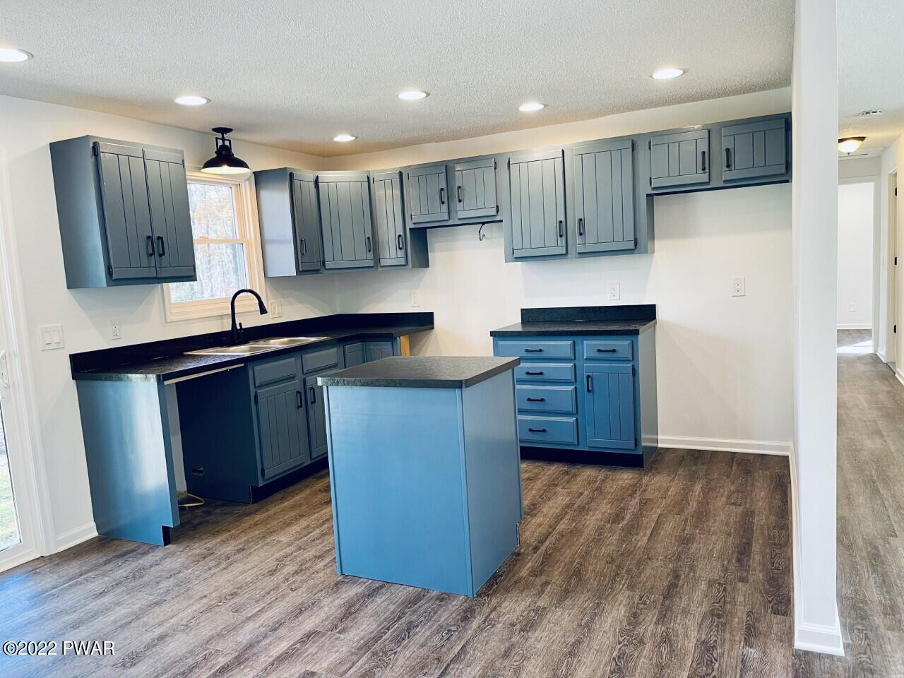 197 Gold Key Road Milford, PA 18337 - Photo 2 of 34 a kitchen with wooden floors and wooden cabinets