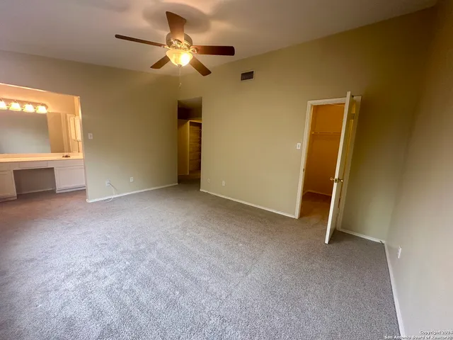a view of a livingroom with a ceiling fan and window