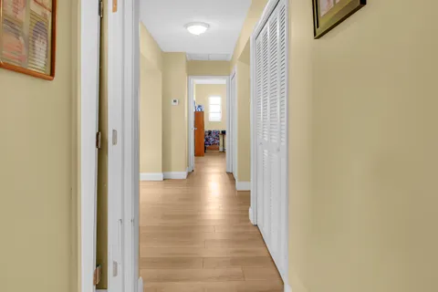 a view of a hallway with wooden floor