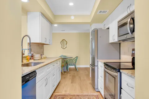 a kitchen with a sink appliances and cabinets