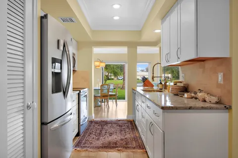 a kitchen with stainless steel appliances granite countertop a refrigerator and a sink