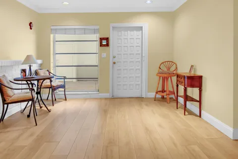 a view of a room with furniture and wooden floor