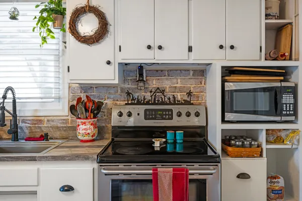 a view of a kitchen area with furniture and wooden floor