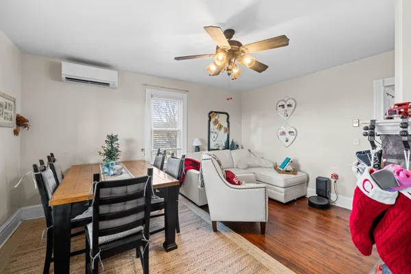a view of kitchen and living room with wooden floor