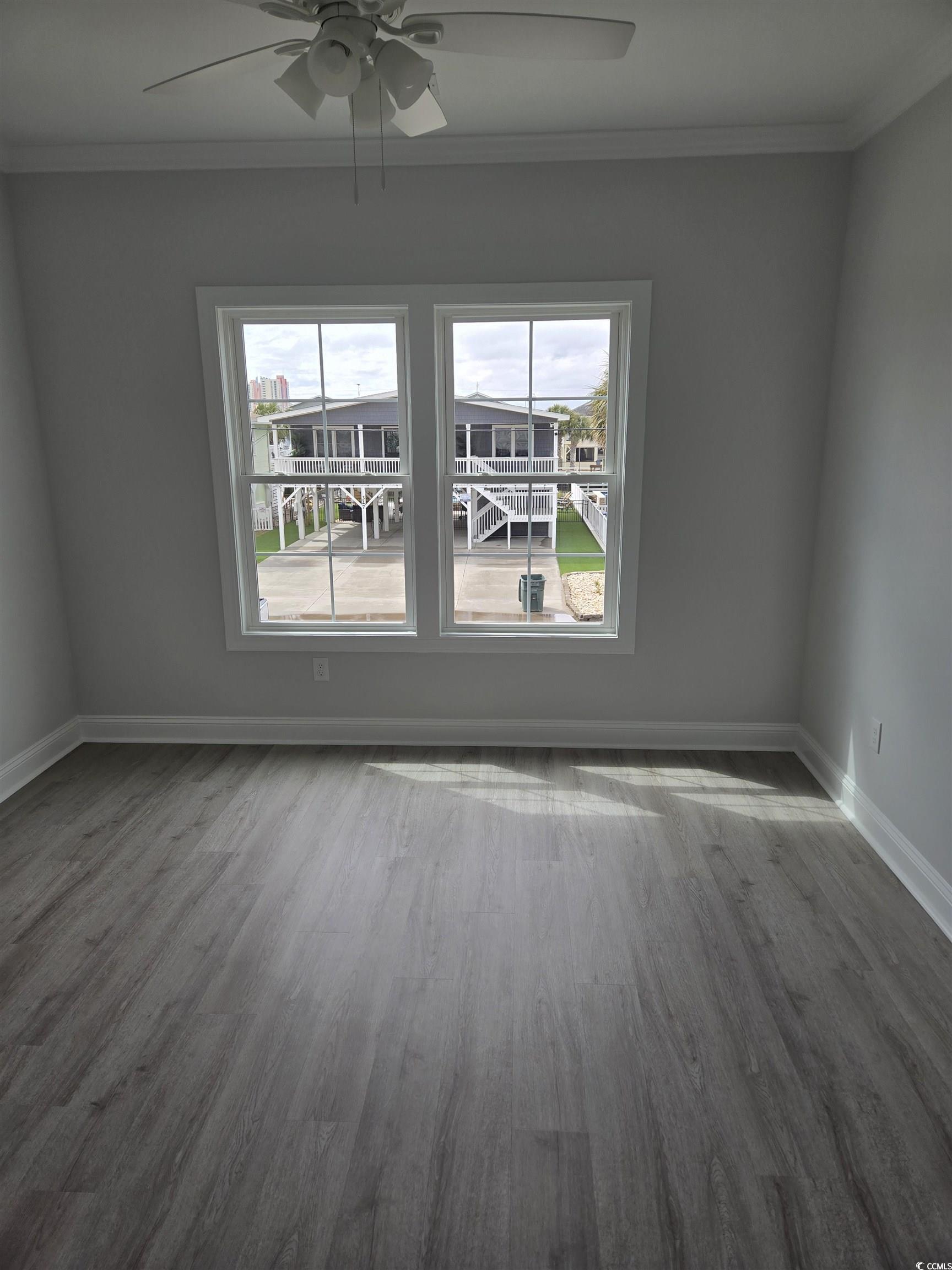 4823 Riverside Drive North Myrtle Beach, SC 29582 - Photo 8 of 14 Empty room with ceiling fan, ornamental molding, b