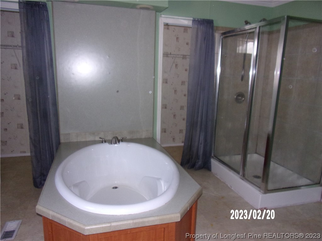 145 Box Elder Terrace Cameron, NC 28326 - Photo 12 of 17 a bathroom with a tub and shower
