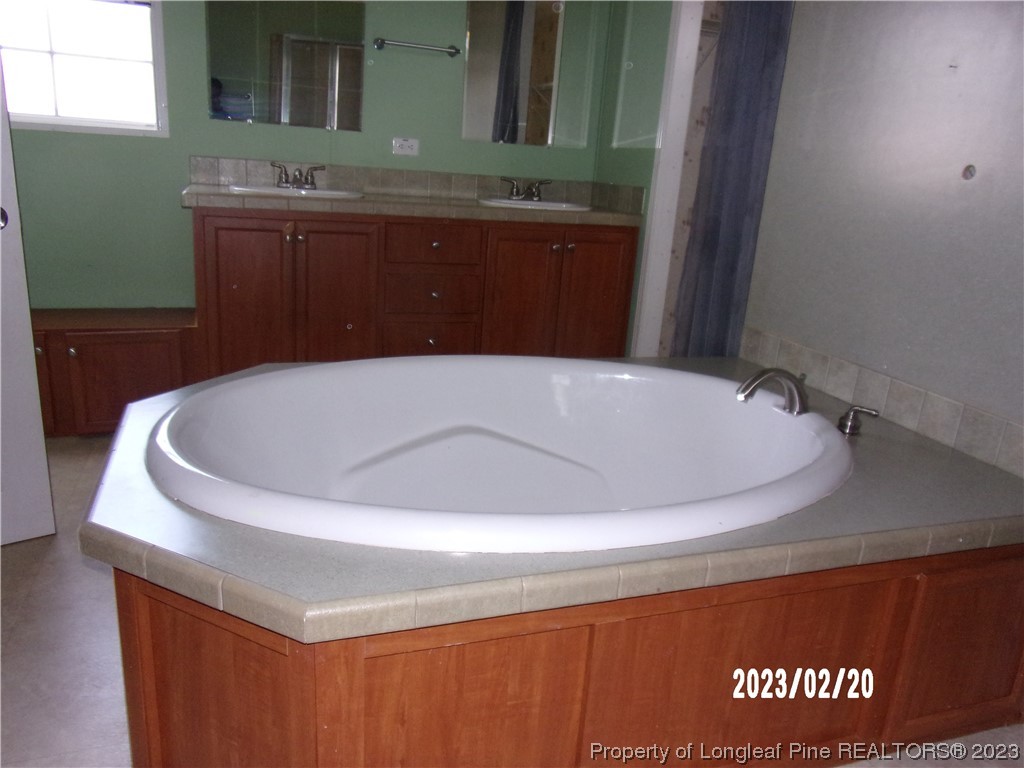 145 Box Elder Terrace Cameron, NC 28326 - Photo 13 of 17 a bathroom with a tub and sink
