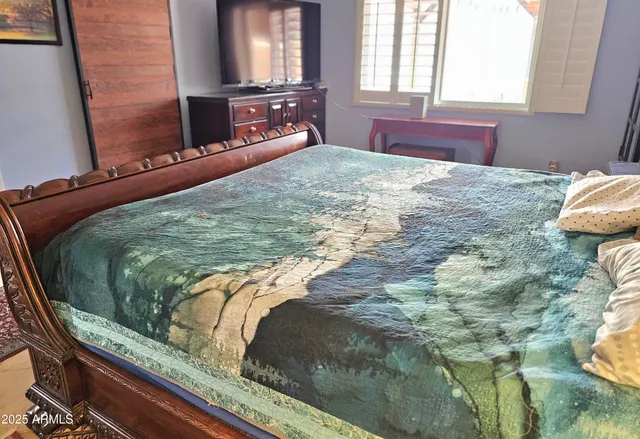 a bedroom with a bed and window