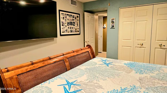 a bedroom with a bed and a painting on the wall