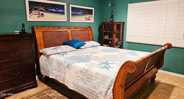 a bed sitting in a bedroom next to a window