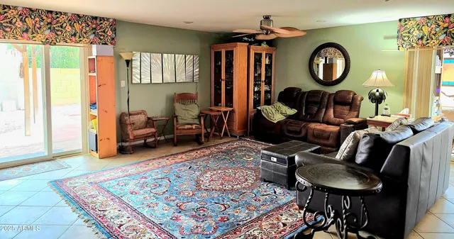 a living room with furniture a rug and a large window