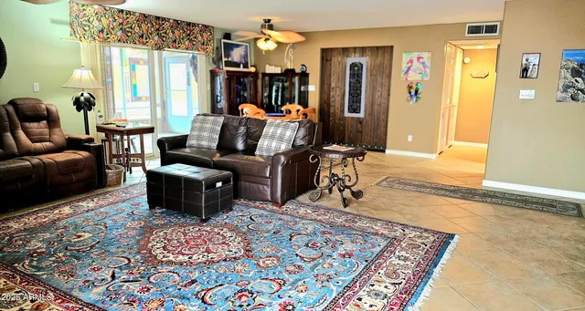 a living room with furniture a rug and a chandelier