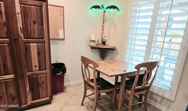 a view of a dining room with furniture and a window