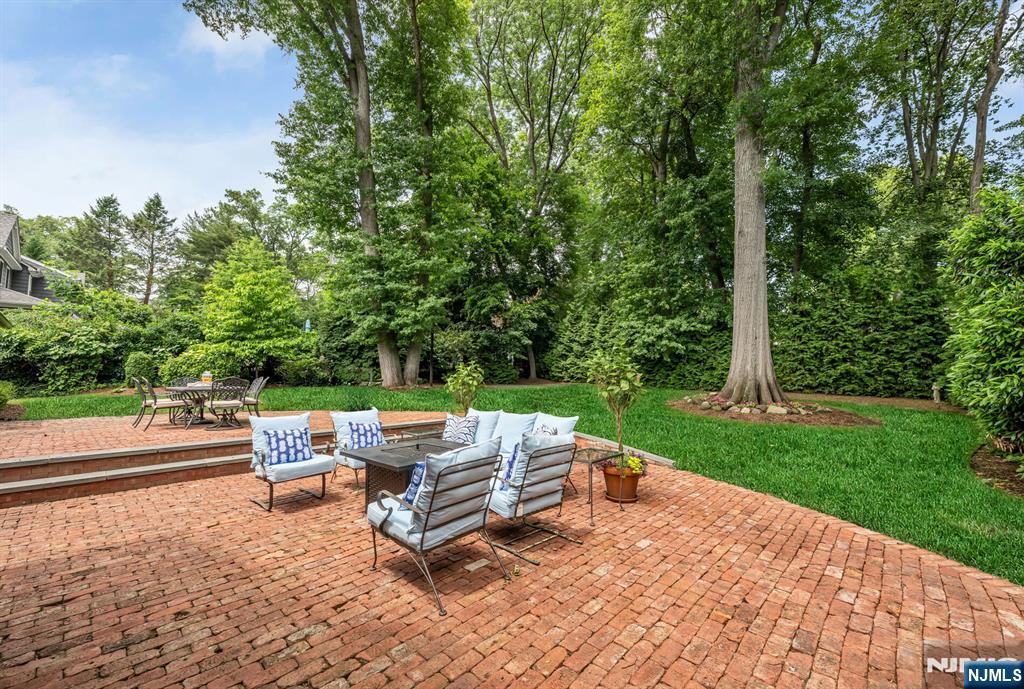 101 Ardmore Road Ho-Ho-Kus, NJ 07423 - Photo 1 of 3 a backyard of a house with table and chairs