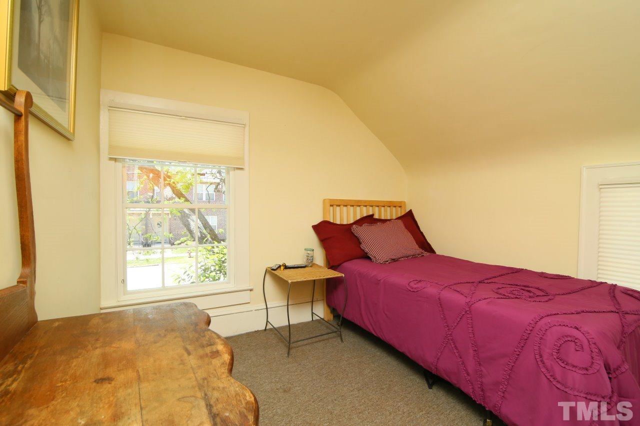 526 North Person Street Raleigh, NC 27604 - Photo 17 of 25 a bedroom with a bed and wooden floor